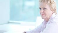 Senior white woman sitting alone